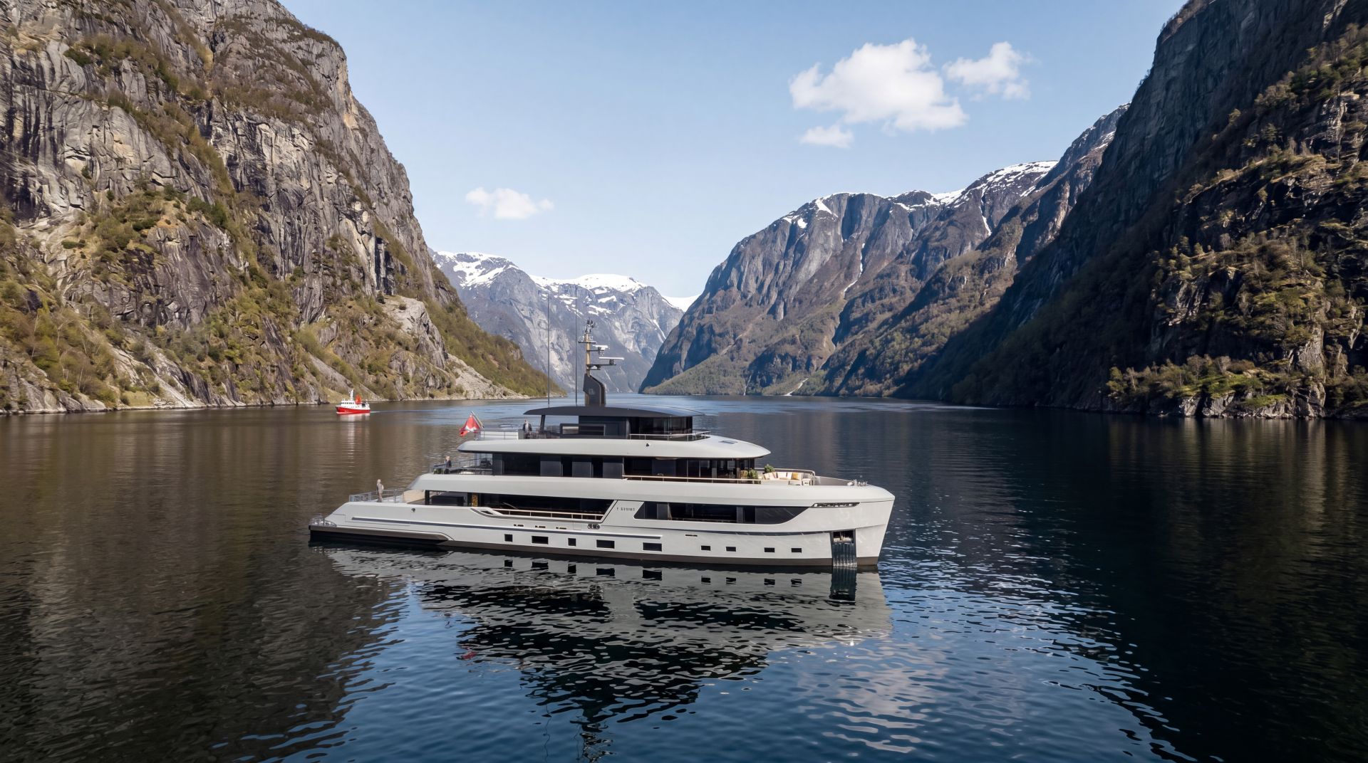 Modern motor yacht framed by dramatic mountains
